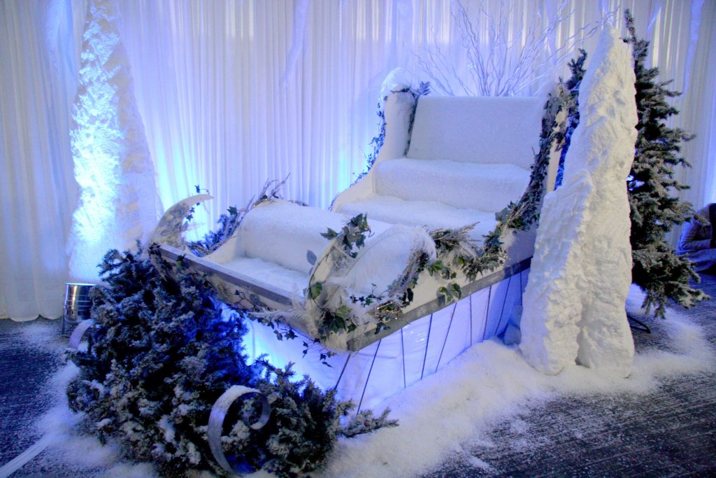 White sleigh with fake snow icicles and christmas trees