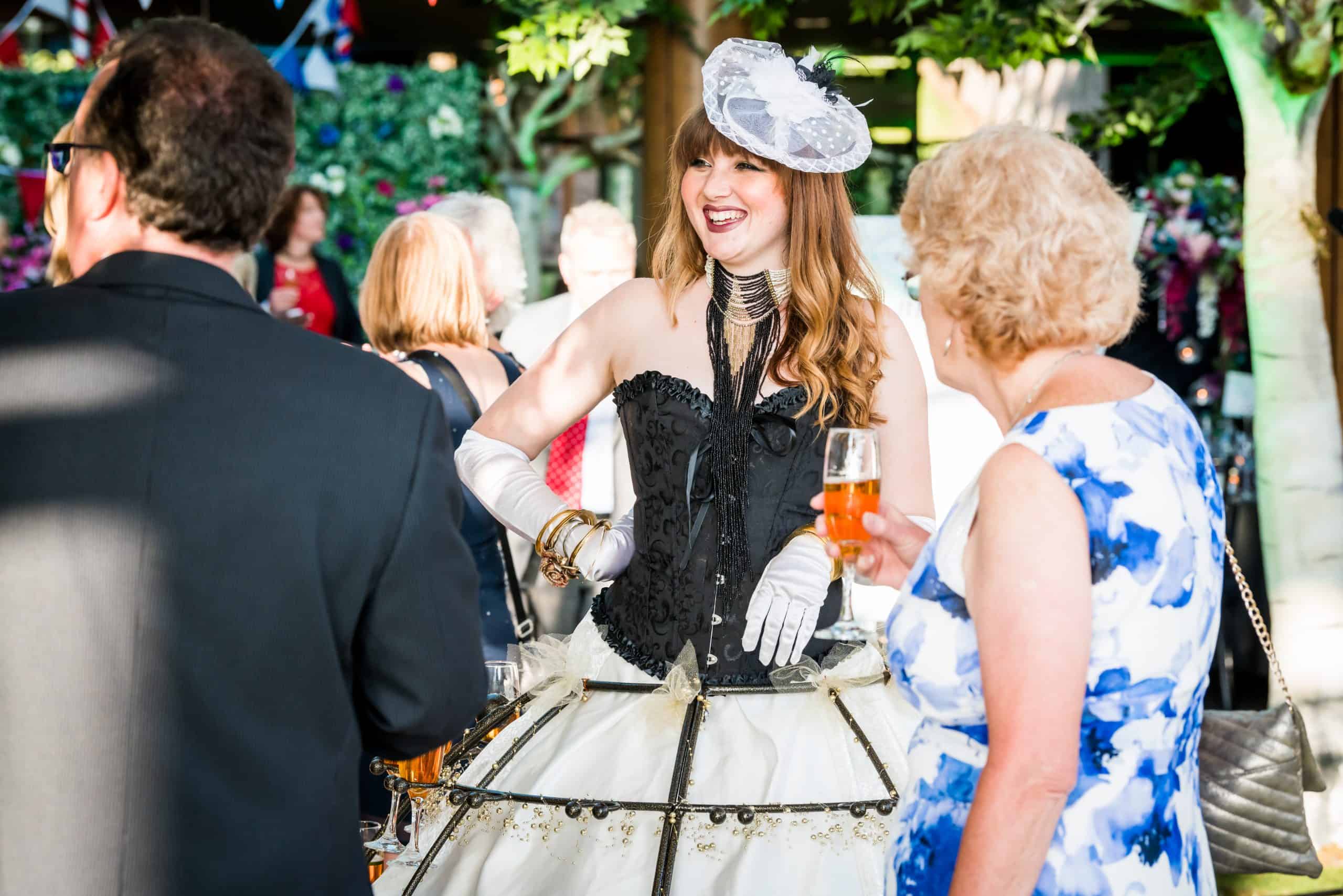 Lady dressed up with corset and head dress laughing entertaining performing waitress Champagne dress