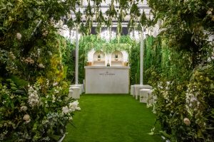 Outside themed room with foliage and flowers tunnels entrances vip area seating white furniture