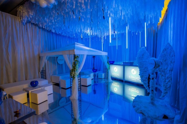 Blue Ciroc room with white marquee and chairs feather photo opportunities mirror floor white furniture cabana strobe hanging lighting