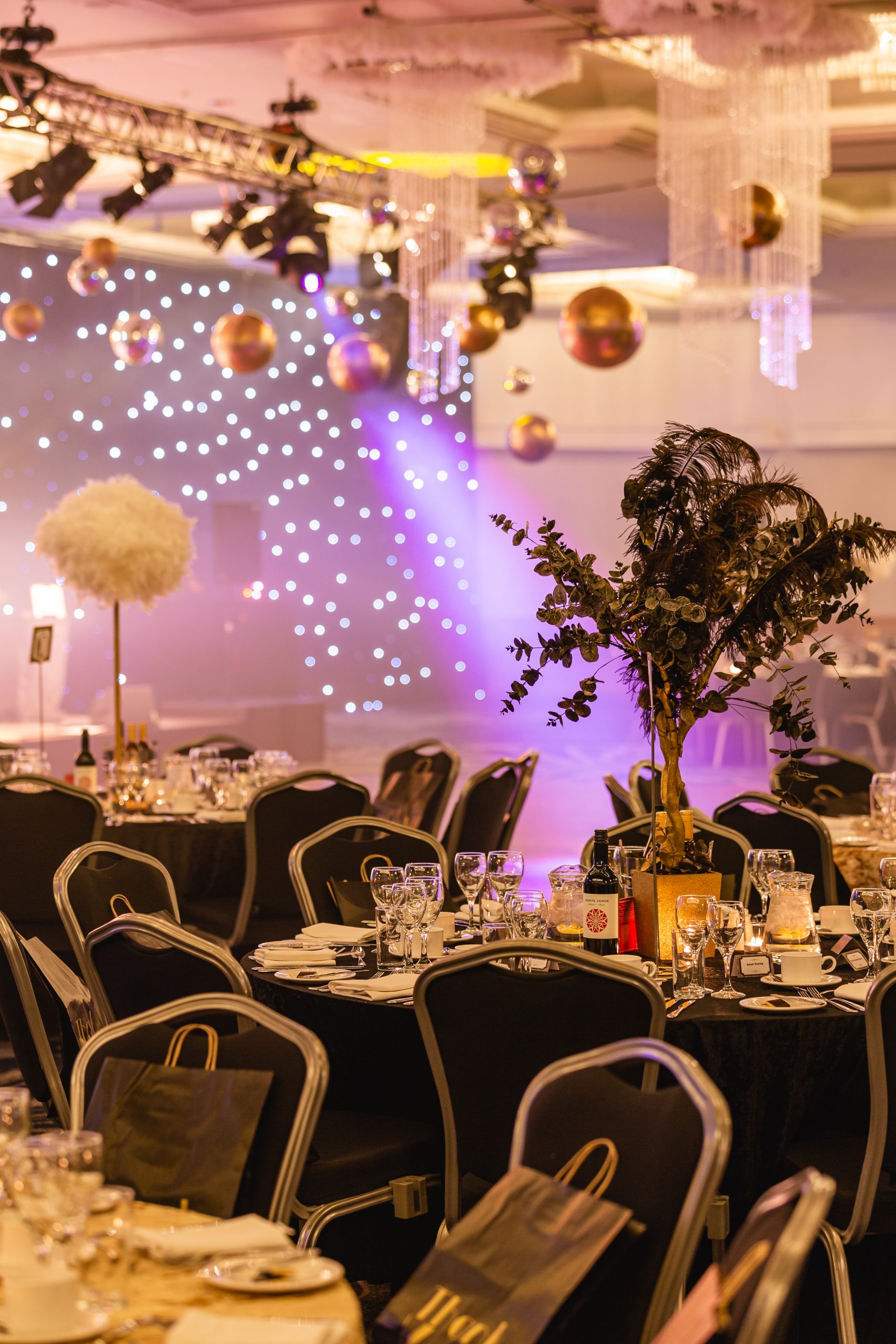 helping hands gala dinner awards ceremony feather and eucalyptus table centres