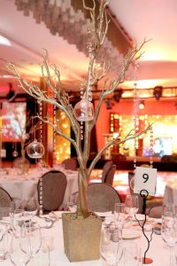 golden tree table centre with crystal hanging from branches with floating pod candles