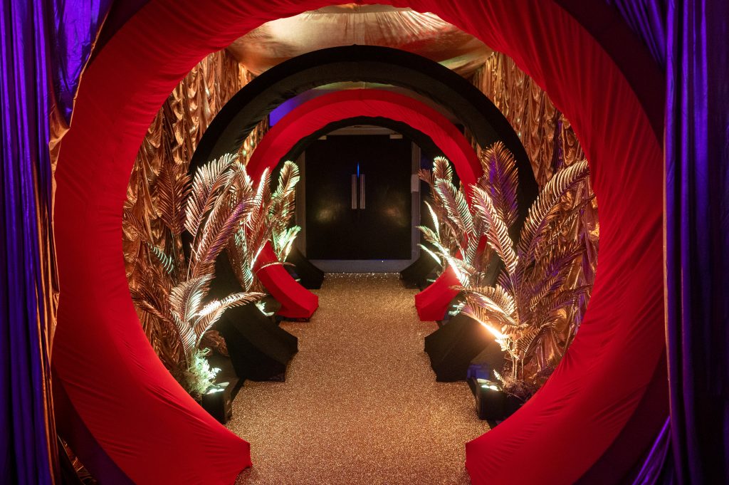 red entrance tunnel with gold leaves