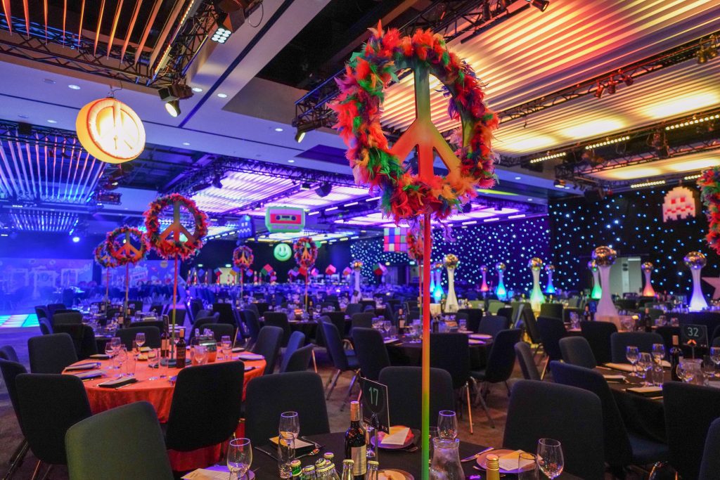 Eventologists 60s Themed Event Multicoloured Hippie 60s Feather Peace Sign Table Centre Hire