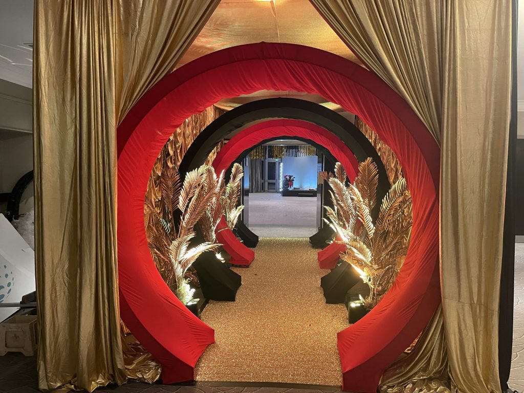 Eventologists Burlesque Themed Event Black And Red Entrance Tunnel Gold Foliage Hire