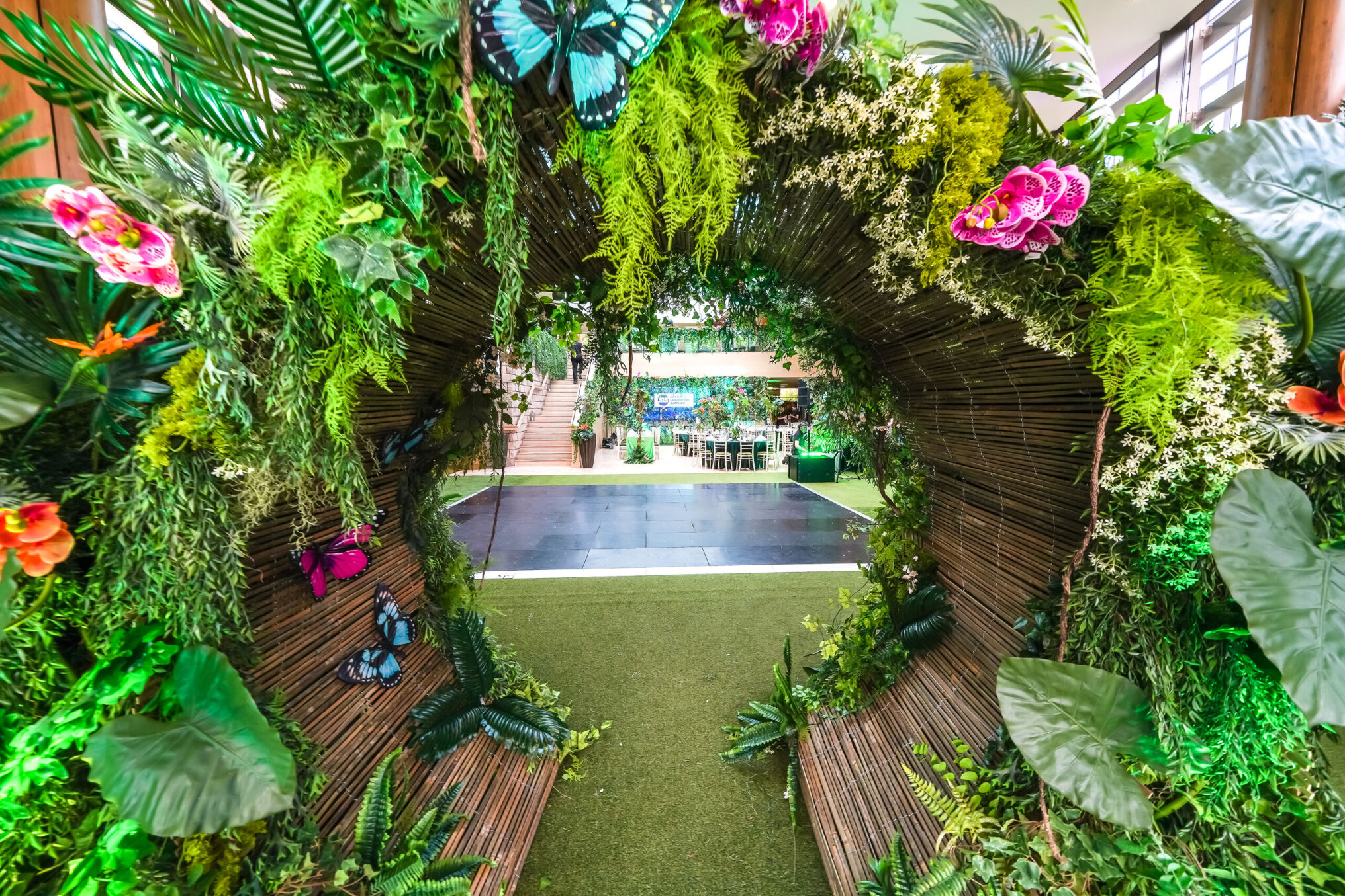Eventologists Neon Jungle Themed Event Entrance Tunnel Foliage Floral Hire