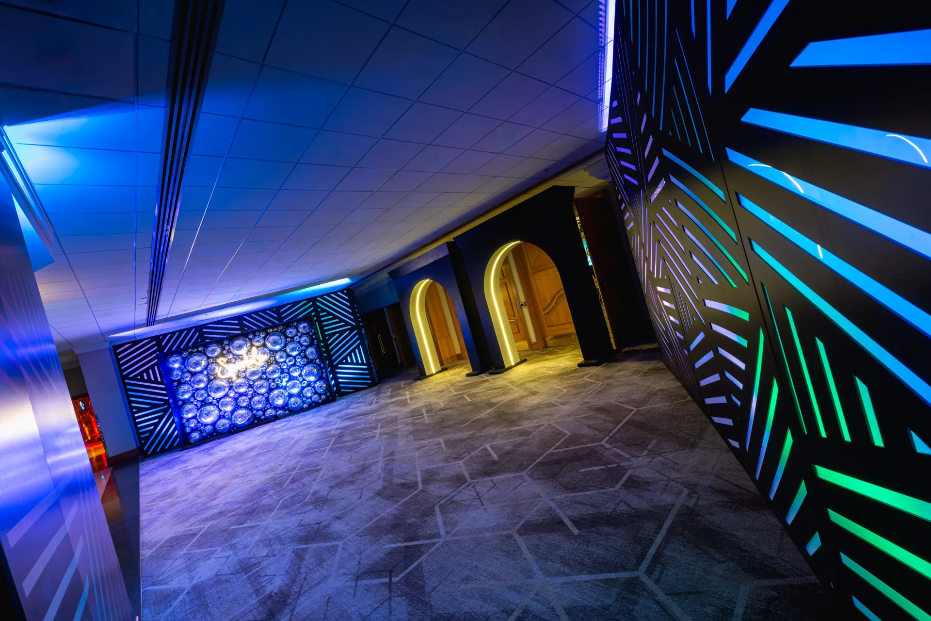 Mirror Ball Feature Wall in Geometric Corridor