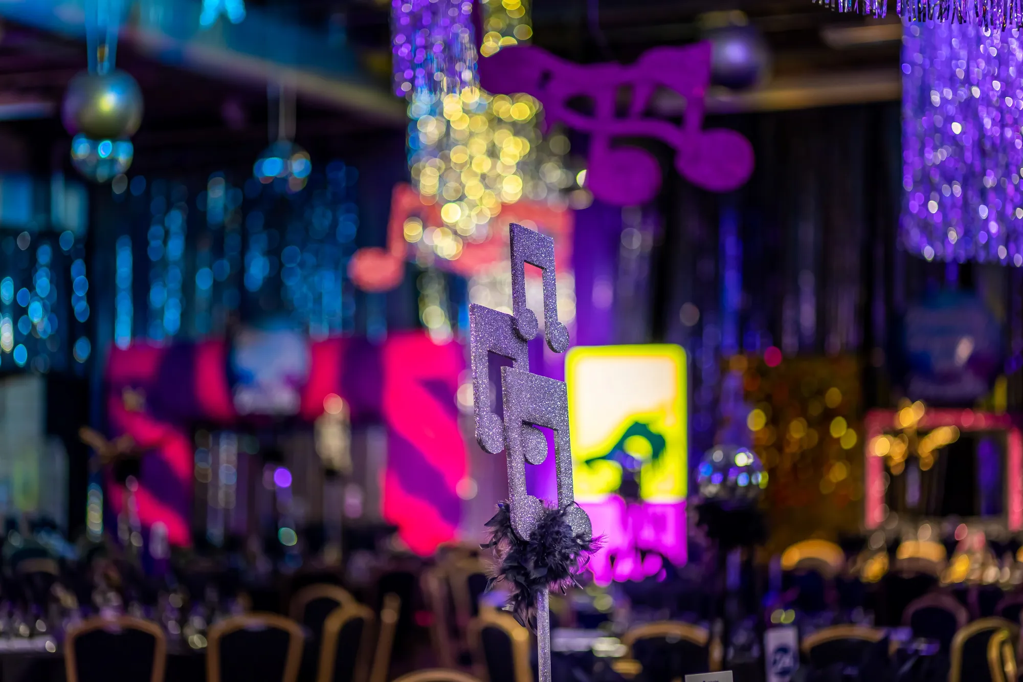 Glitter Music Note Centrepiece Against Colour Bokeh