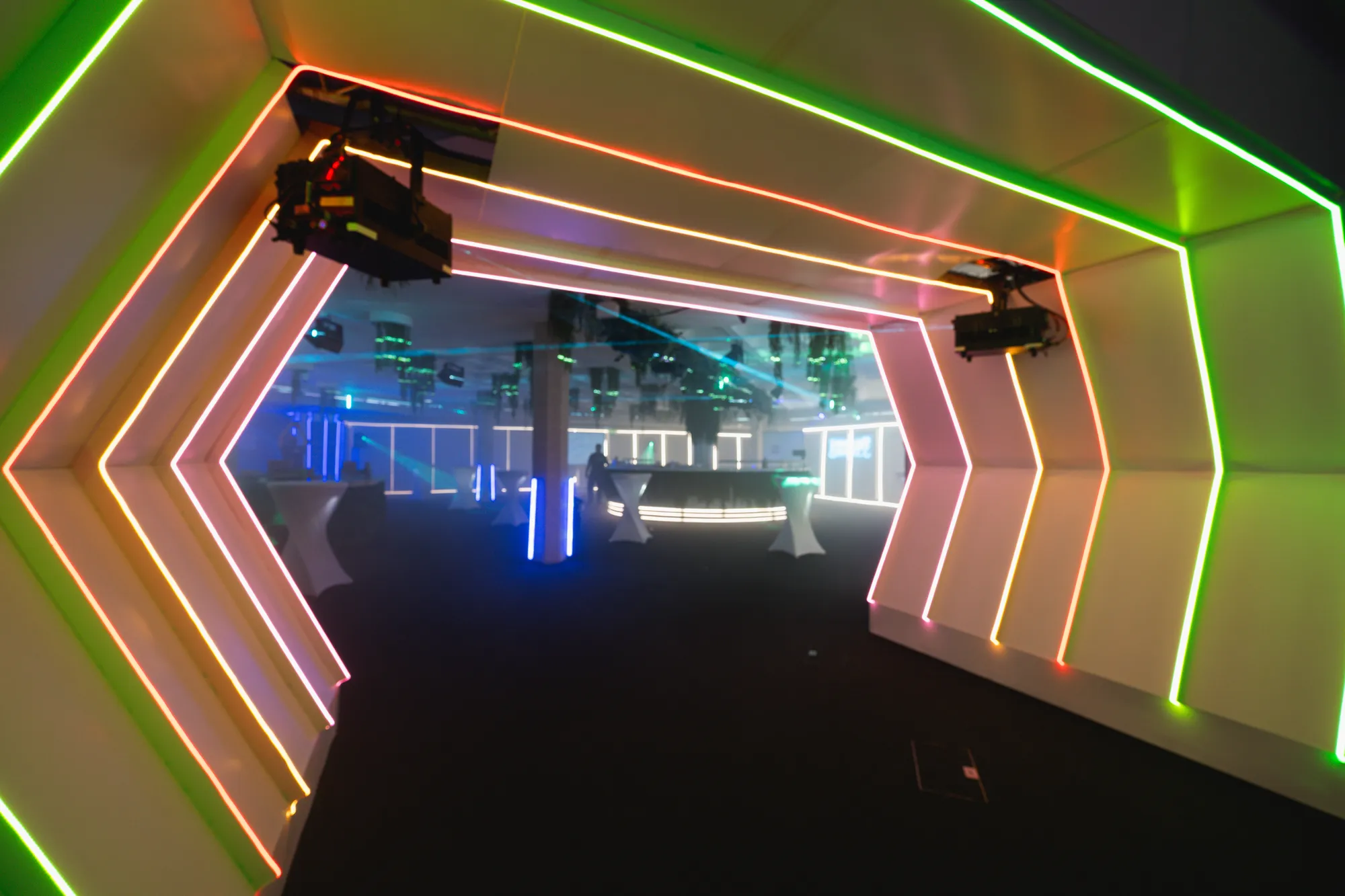 Neon Chevron Tunnel Entrance to Laser-Lit Room