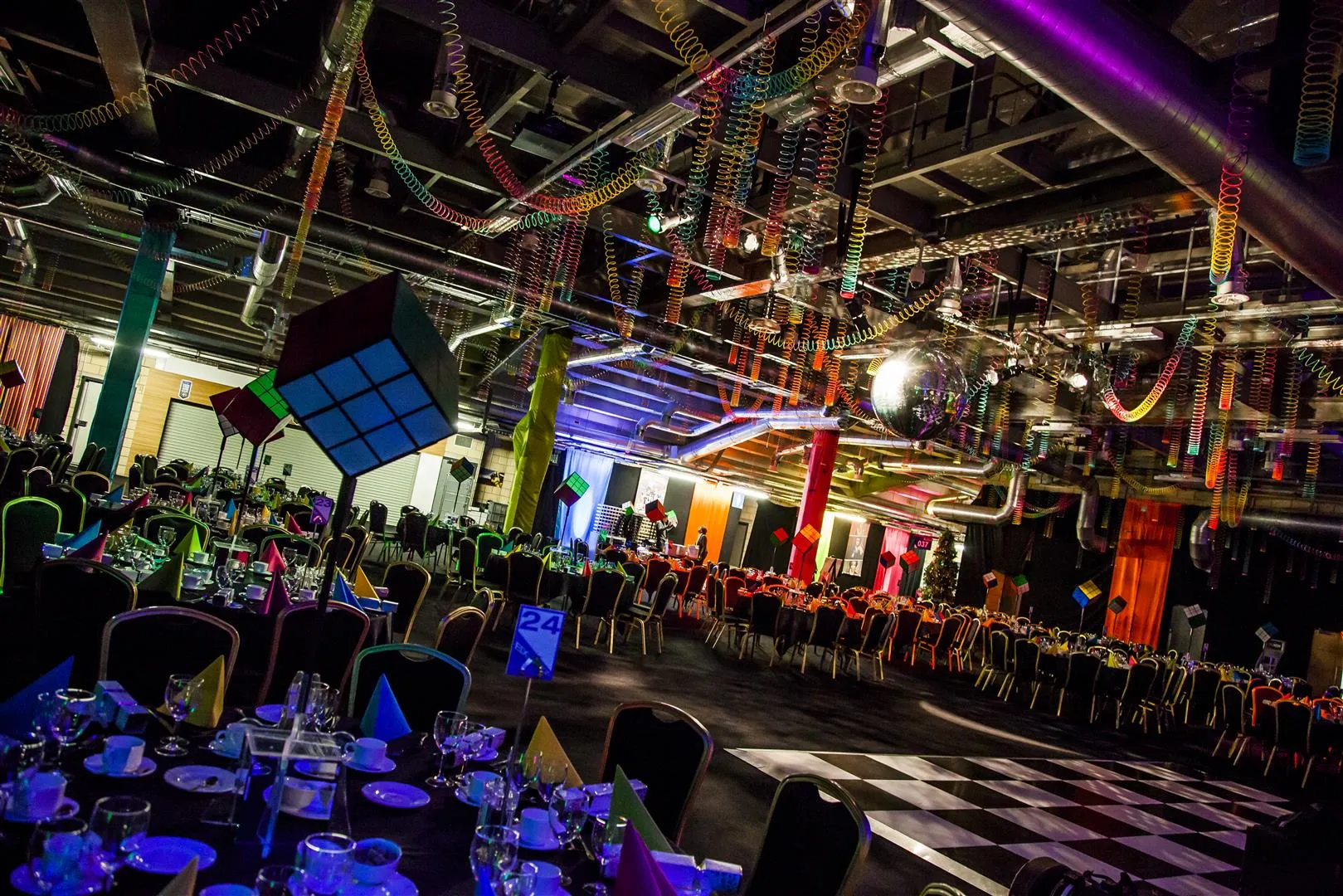 Rubik's Cube Table Centres Under Slinky-Draped Ceiling